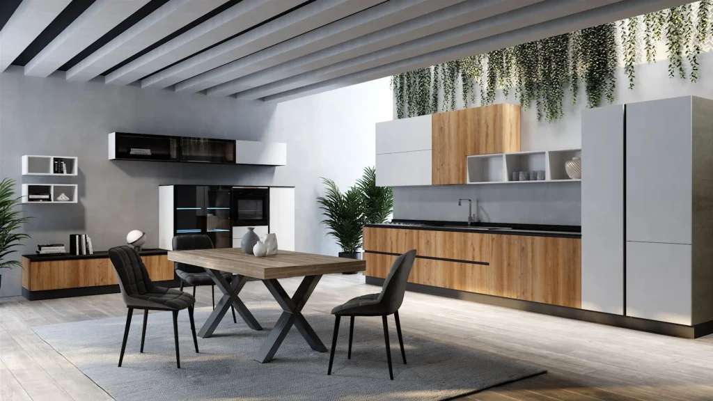 Cucina angolare Dafne Clean di BEHOME con basi in legno, colonne bianche, tavolo centrale e tre sedie scure.