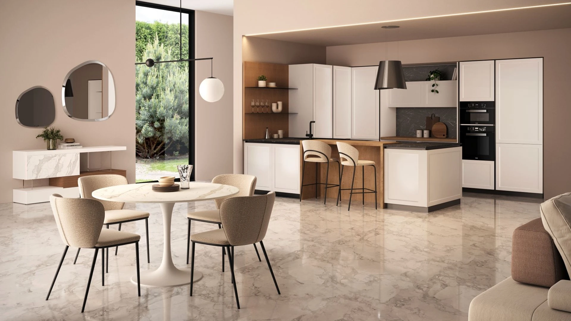 Ampia Cucina Con Penisola Euforia aperta sul living: mobili bianchi, penisola in legno, tavolo rotondo e sedie chiare.