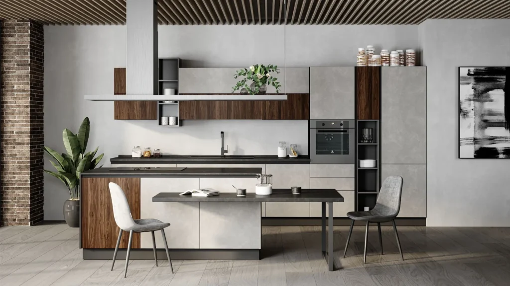 Cucina con isola Libra Gray di BEHOME: mobili grigio cemento, dettagli in legno scuro, tavolo integrato e due sedie.