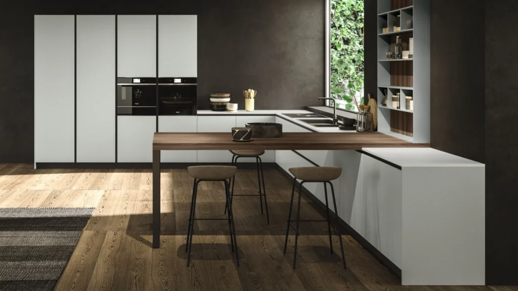 Dettaglio dell'area di lavoro e isola in legno scuro di una cucina moderna Dafne Wild, con forni e scaffali