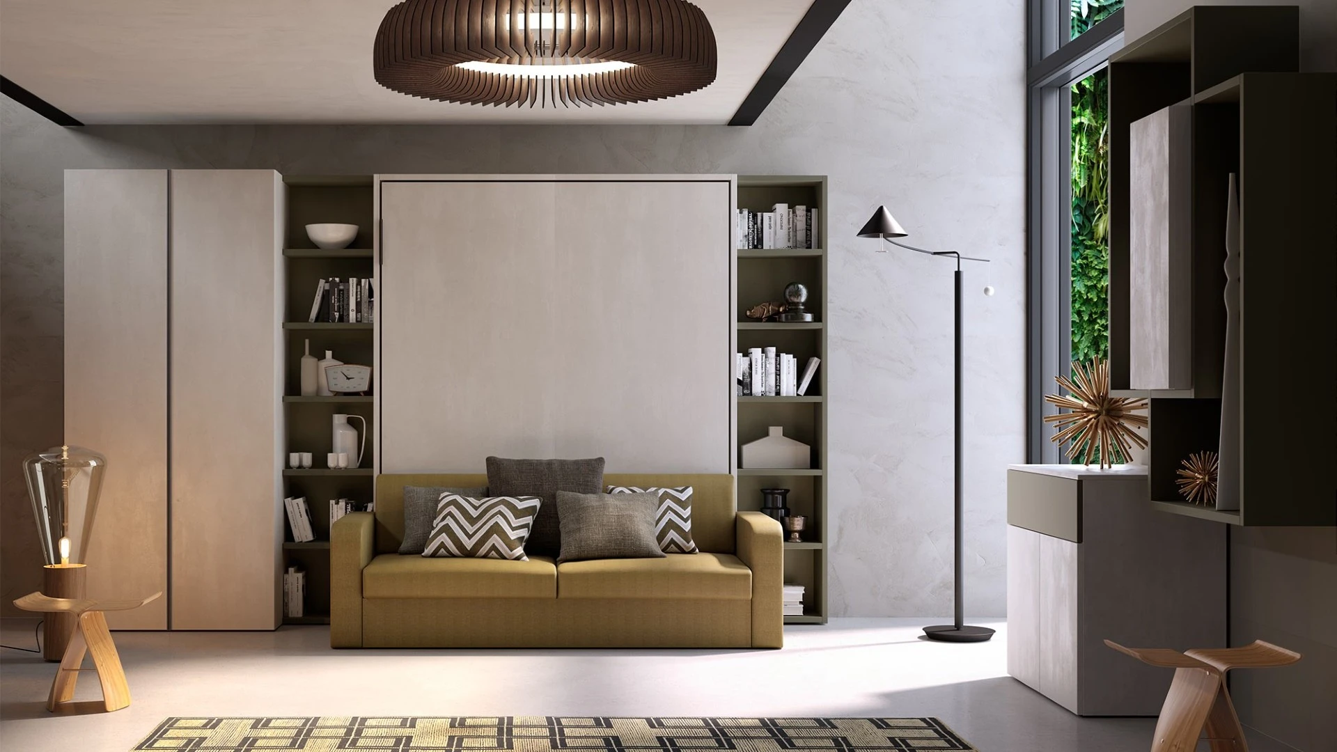 Parete attrezzata Richard trasformabile di BEHOME con divano letto verde senape e moduli libreria.