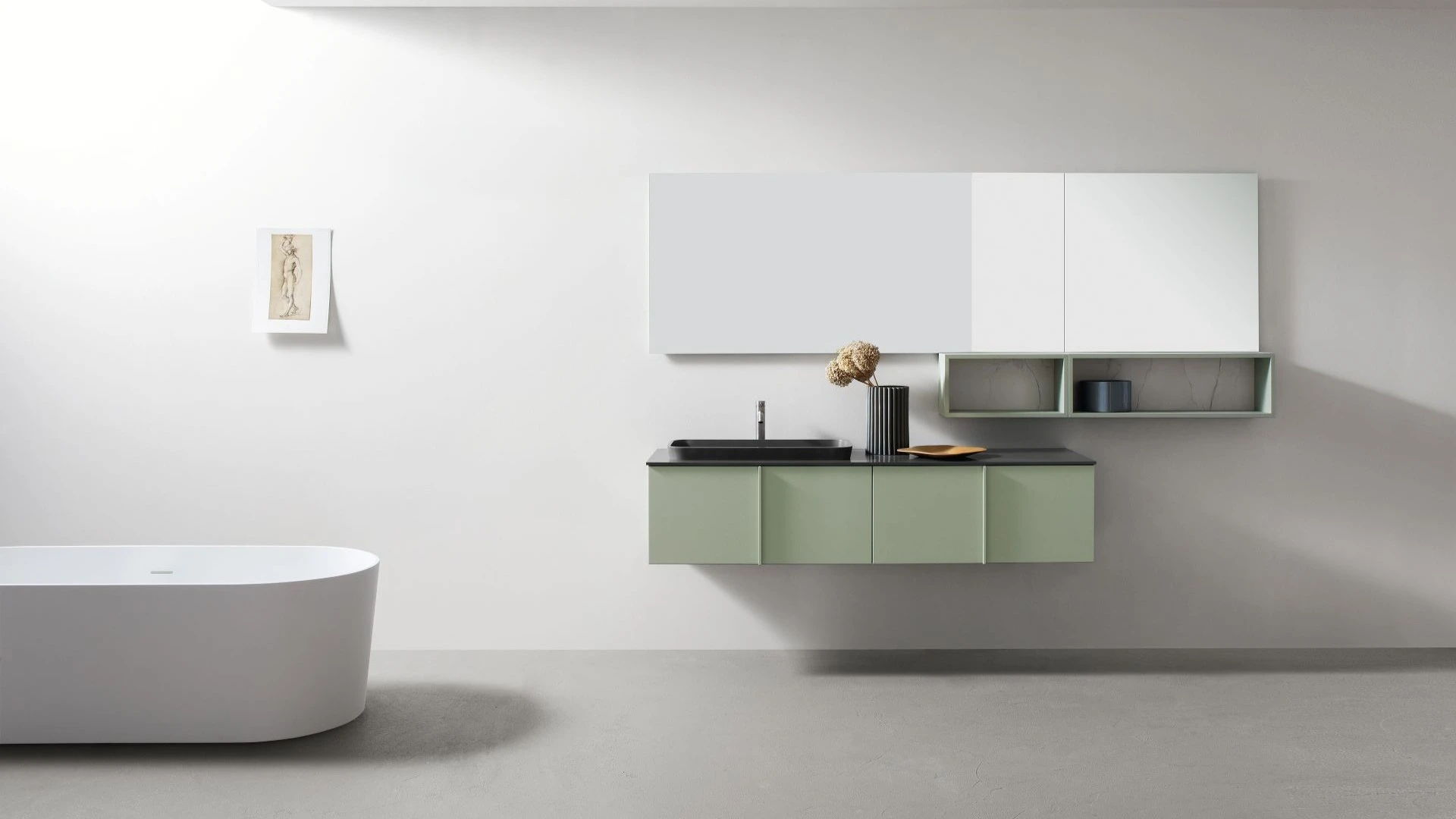 Mobile bagno sospeso Jack di BEHOME verde salvia con lavabo nero in bagno moderno.