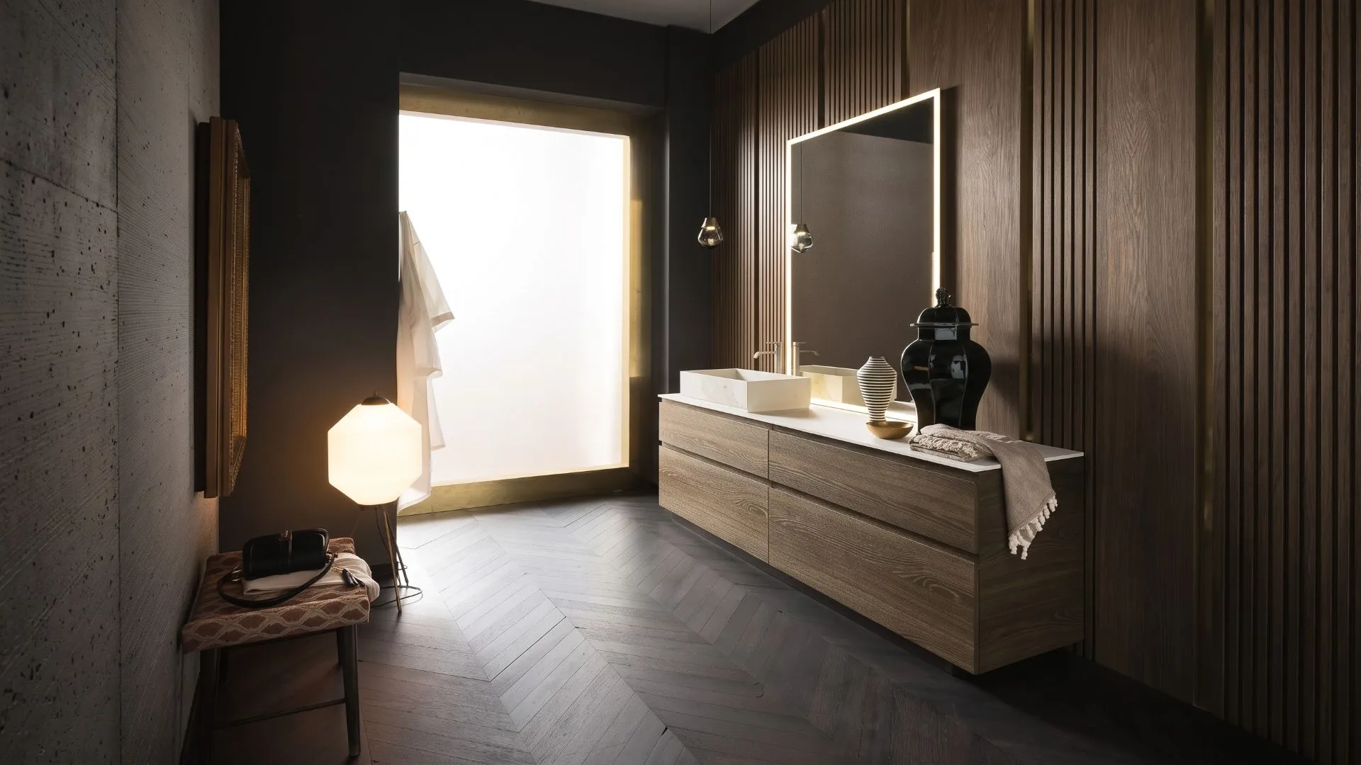 Mobile bagno Miller di BEHOME in legno venato con specchio retroilluminato e lavabo d'appoggio.